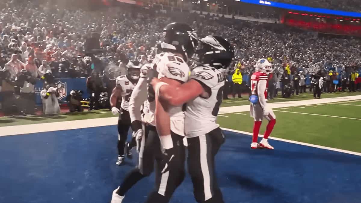 Philadelphia Eagles players celebrating a touchdown in the end zone during a game against the Buffalo Bills, with the crowd in the background.